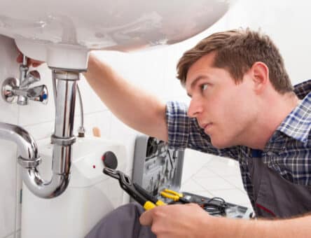 plumber fixing a sink