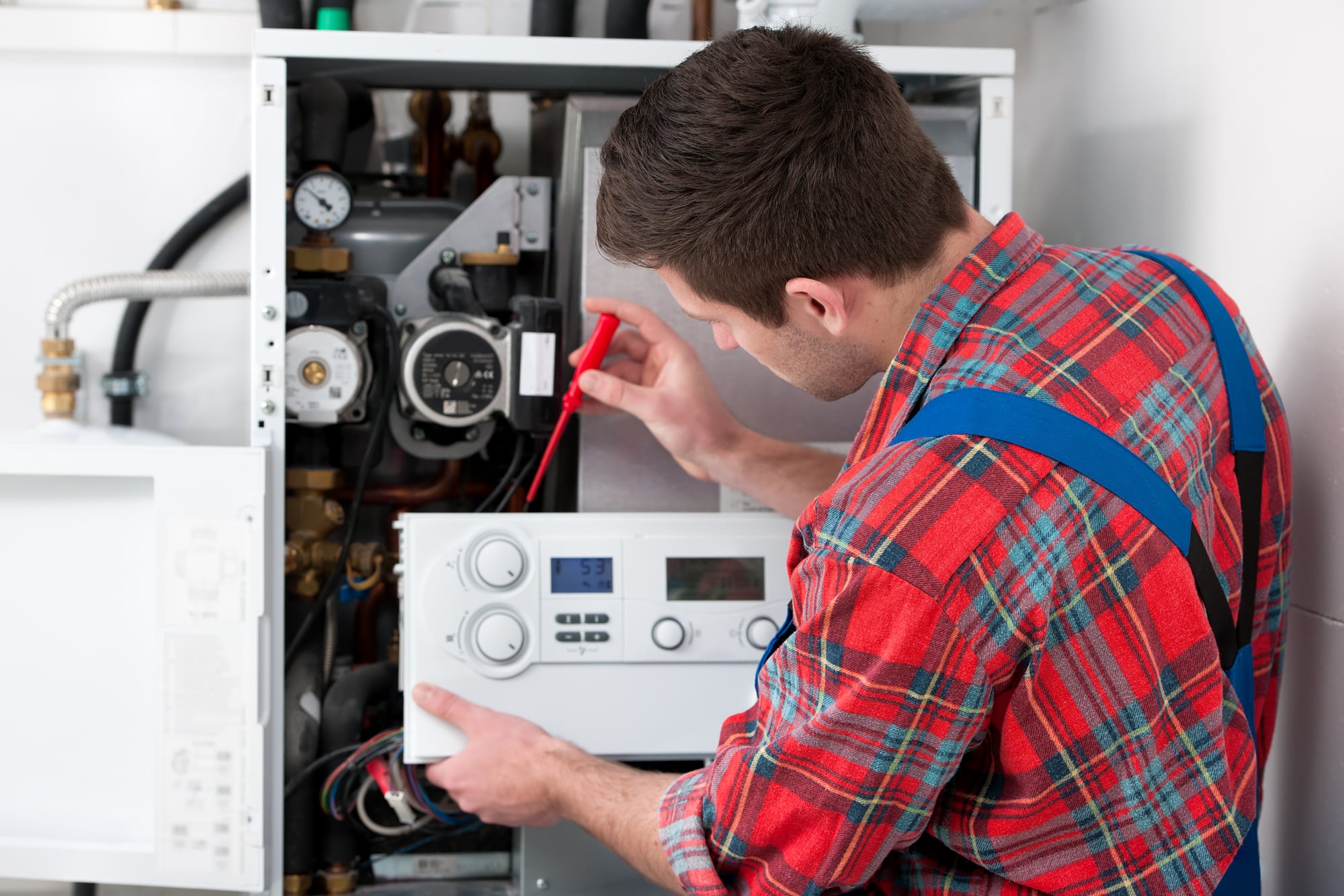 Plumber With Clipboard checkin an Electric Boiler - Tom's Plumbing and Drain Service, LLC
