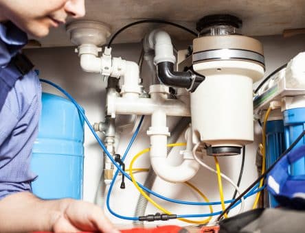 Plumber at work -Tom's Plumbing & Drain Service, LLC