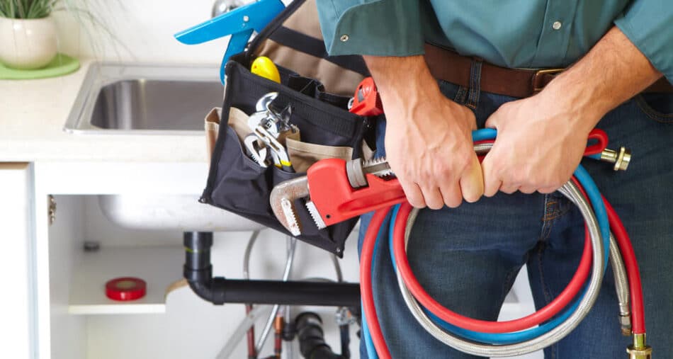 Plumber with set of tools - Tom's Plumbing
