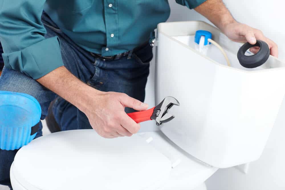 The worker with a plunger - Tom's Plumbing