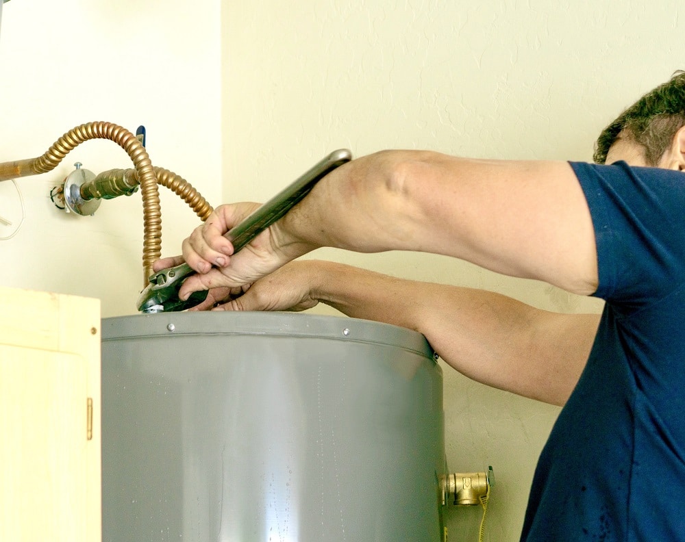 adult male using a wrench to make adjustments
