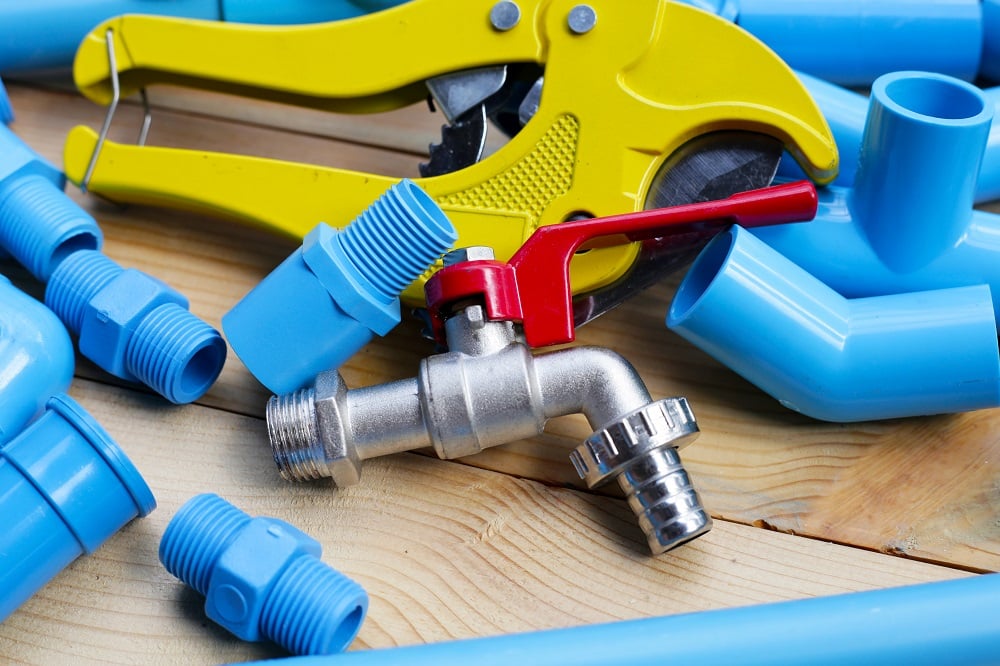 Plumber equipment with blue pvc pipe connections for plumbing work.