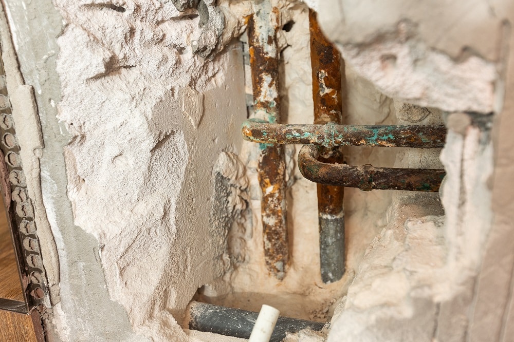Home residential problem, damage water piping system in restroom, water leak on wall hole. High quality photo